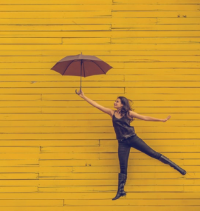 woman with umbrella taking off